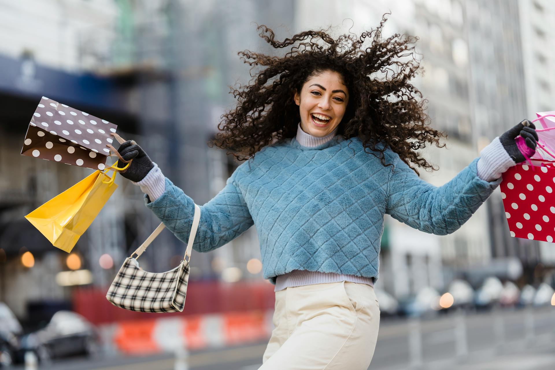 happy-woman-jumping-with-shopping-bags