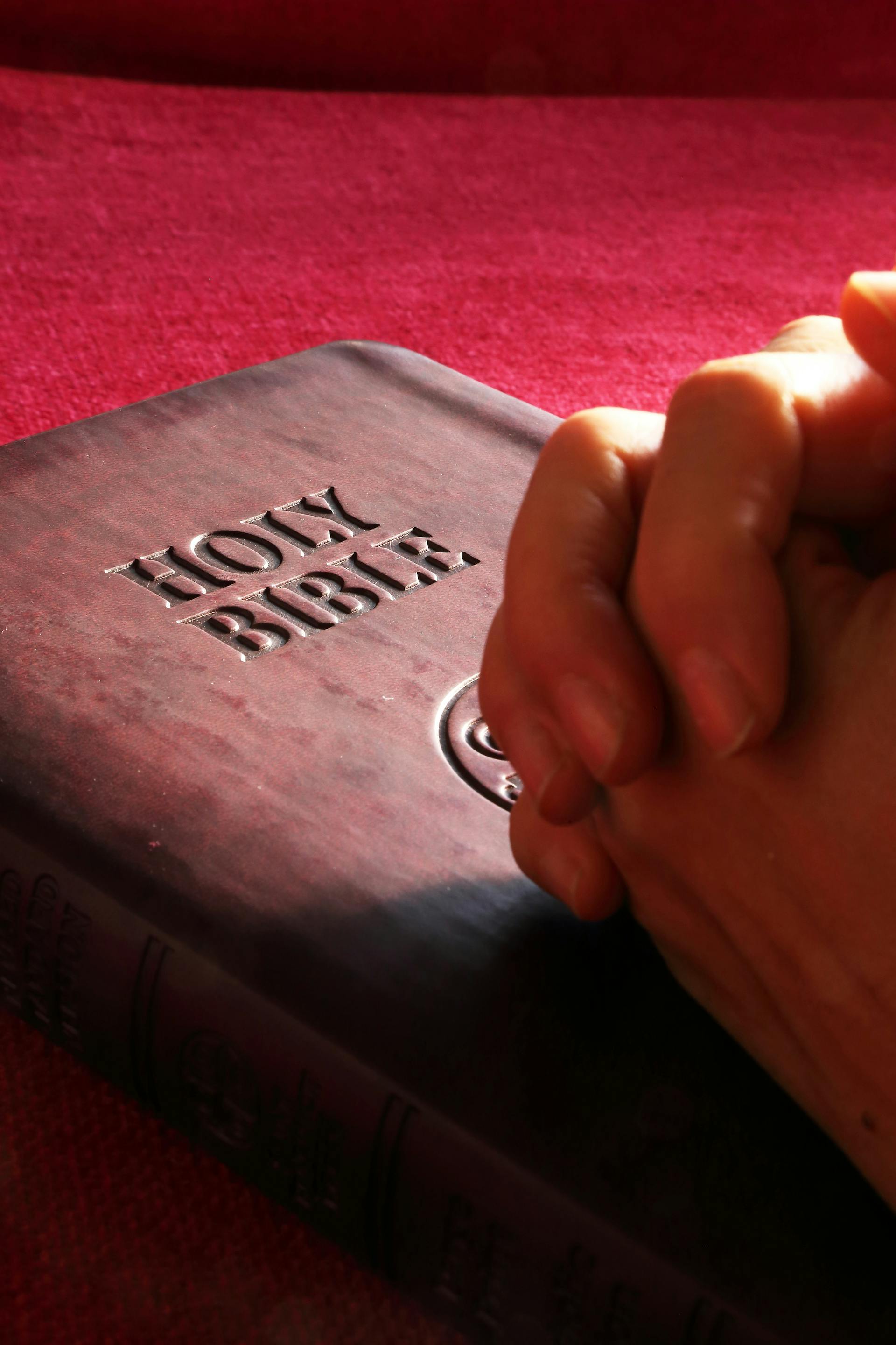 person-hands-on-holy-bible