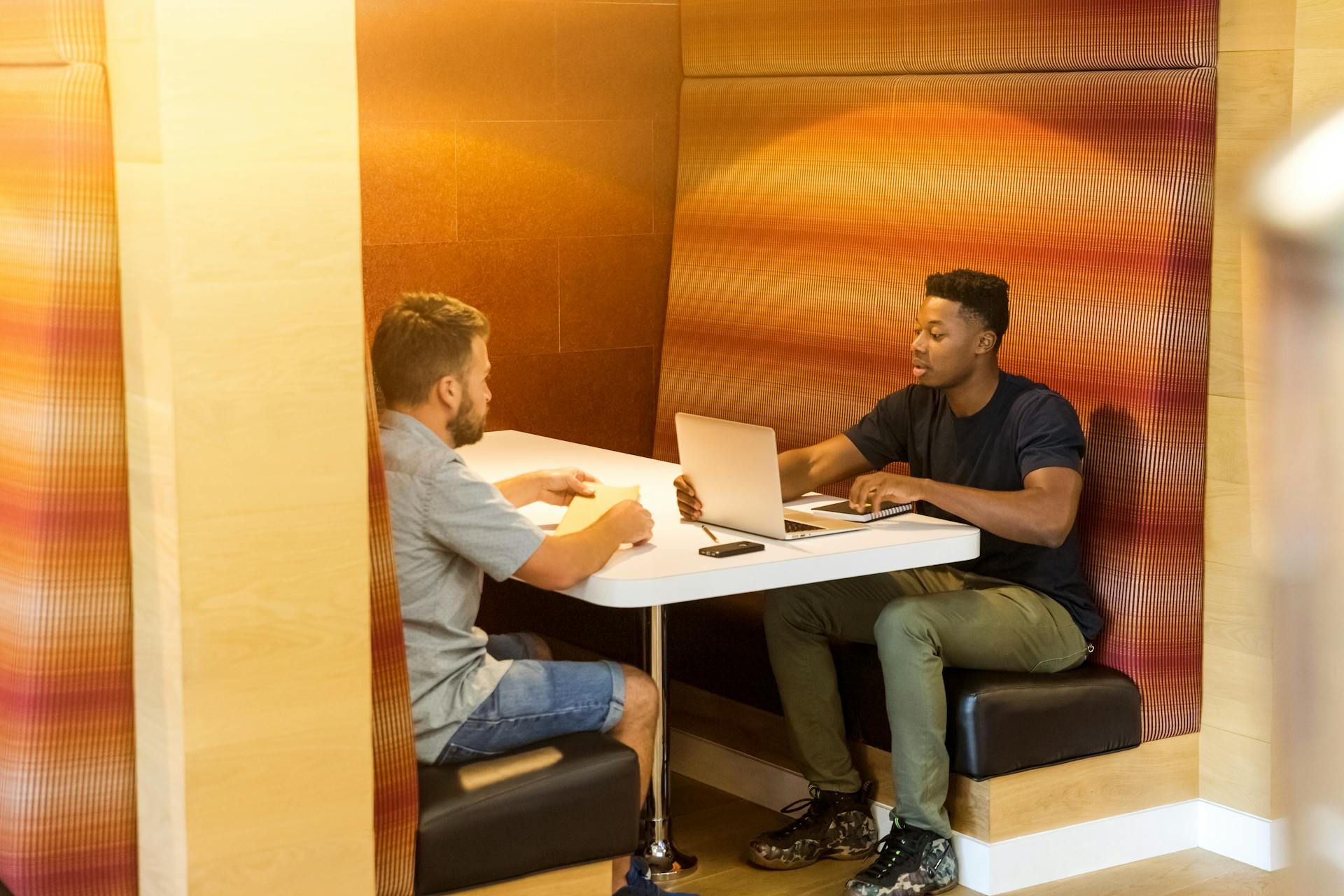 two-man-sitting-beside-table