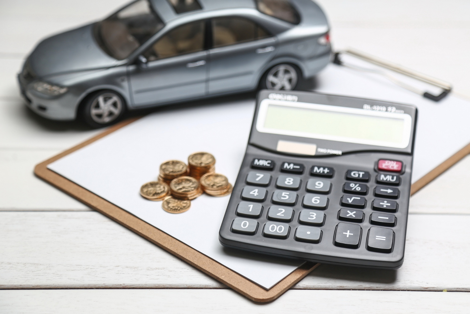 car-model-calculator-coins-white-table