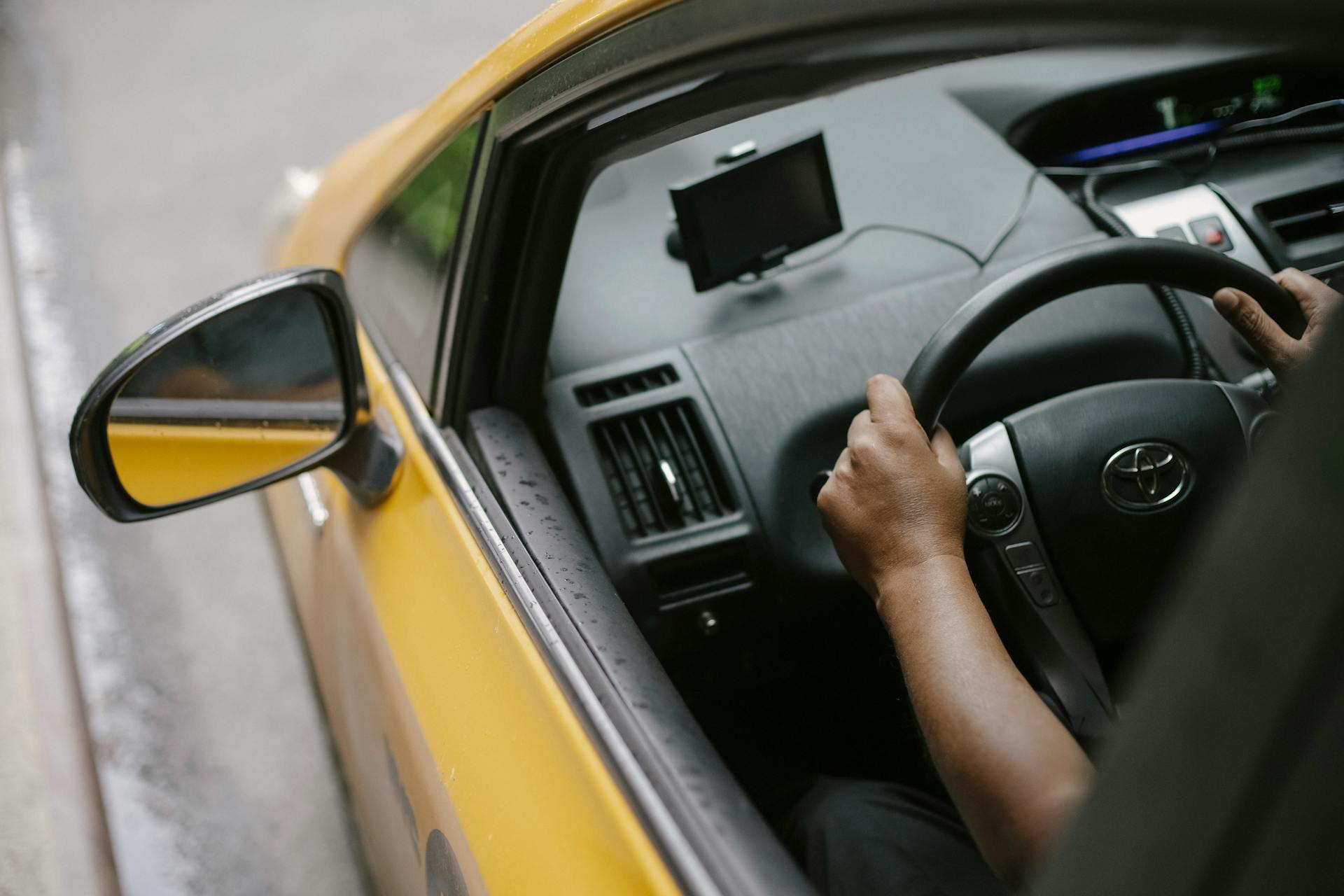 faceless-person-driving-contemporary-cab-in-city