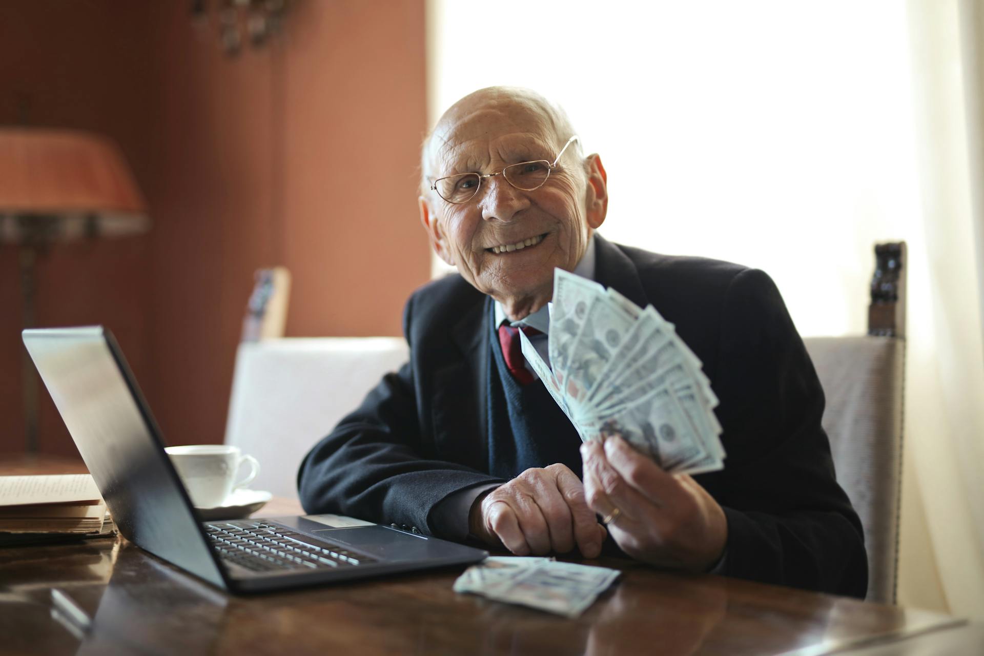 happy-senior-businessman-holding-money-in-hand