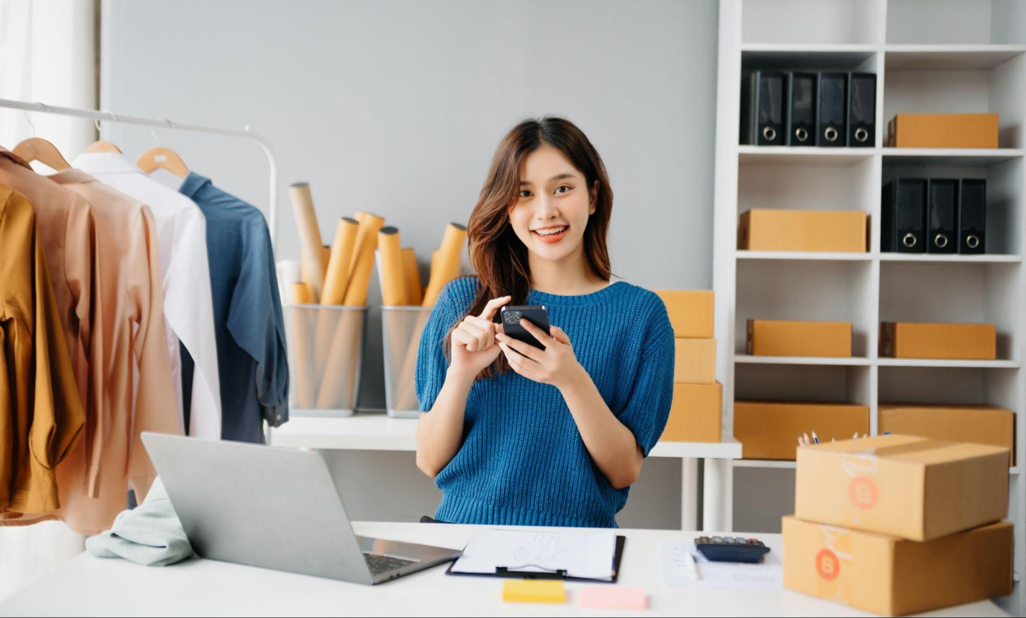 A Woman Browsing Clothing Display on phone