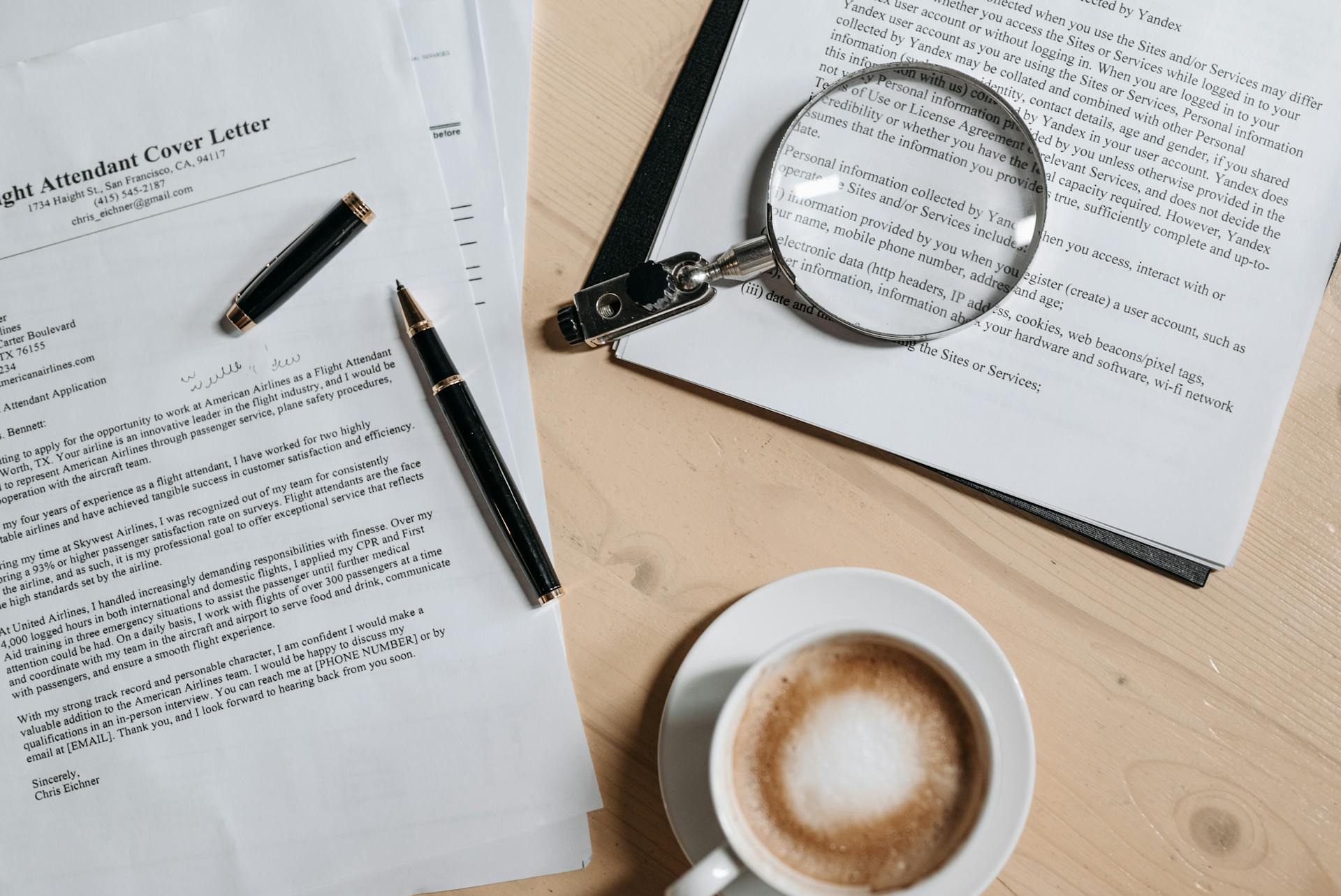 coffee-pen-and-magnifying-glass-on-papers