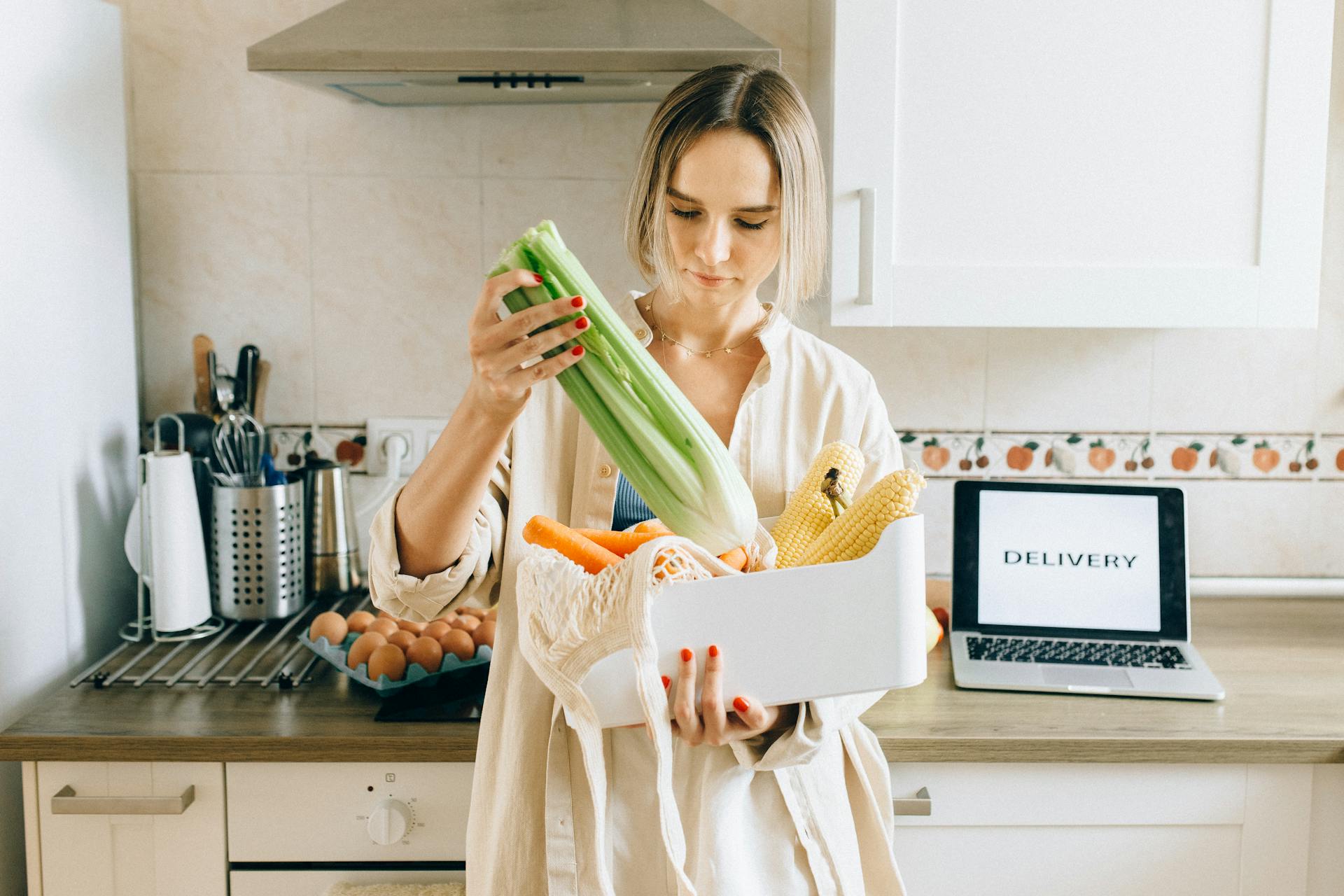 woman-in-white-robe-holding-green-plastic-pack