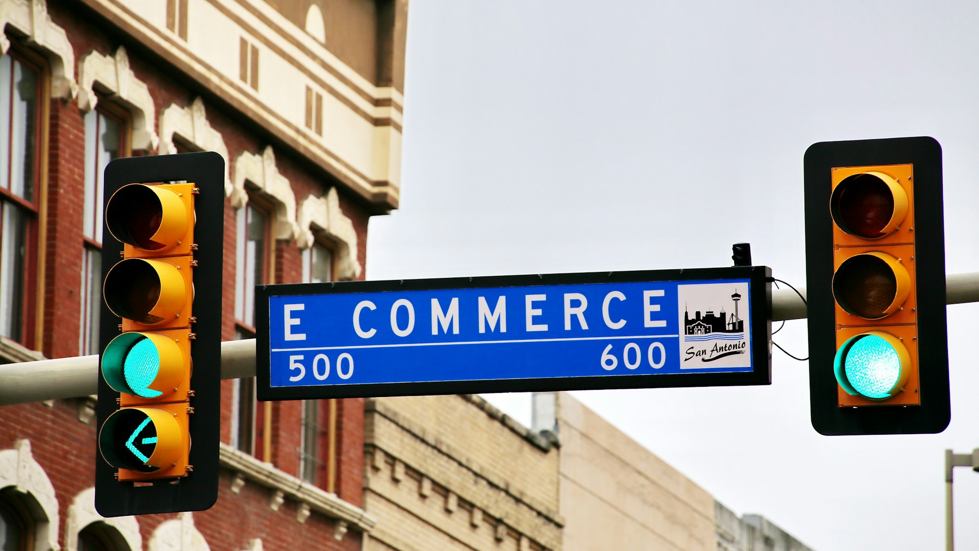 a-traffic-light-with-a-street-sign-hanging