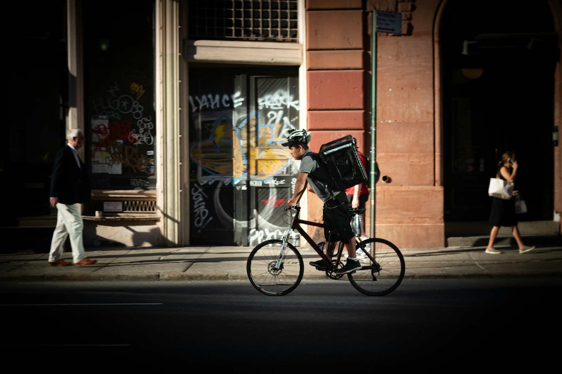 man-riding-bicycle-near-road-during-daytime