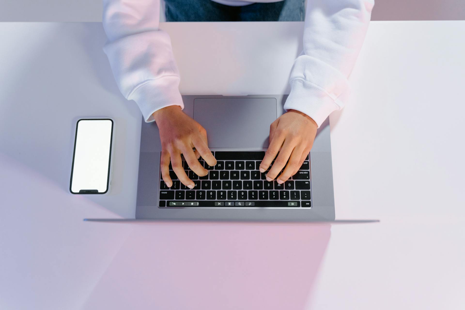 person-in-white-long-sleeve-shirt-using-laptop