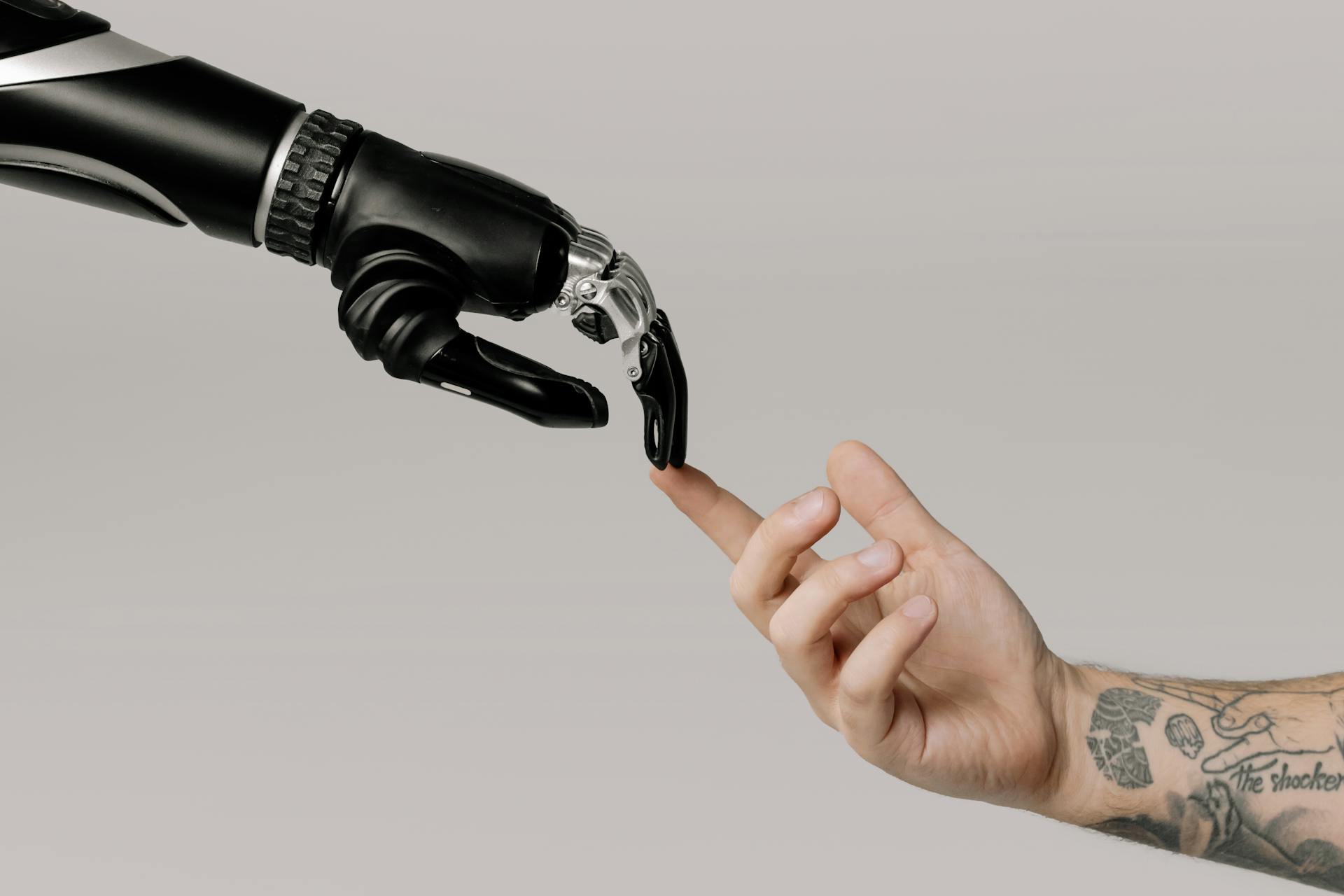 bionic-hand-and-human-hand-finger-pointing