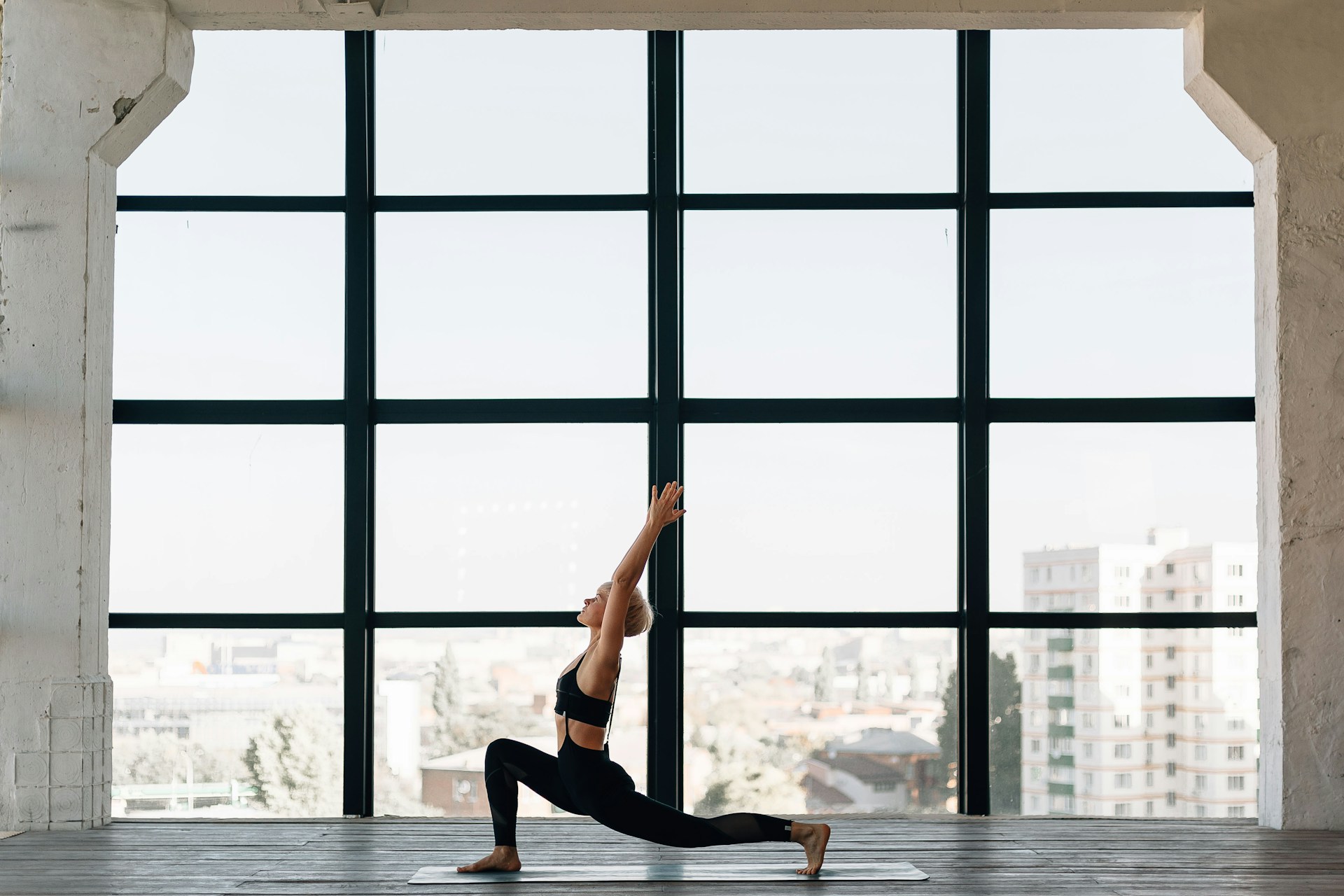 woman-in-black-tank-top-and-black-leggings-doing-yoga