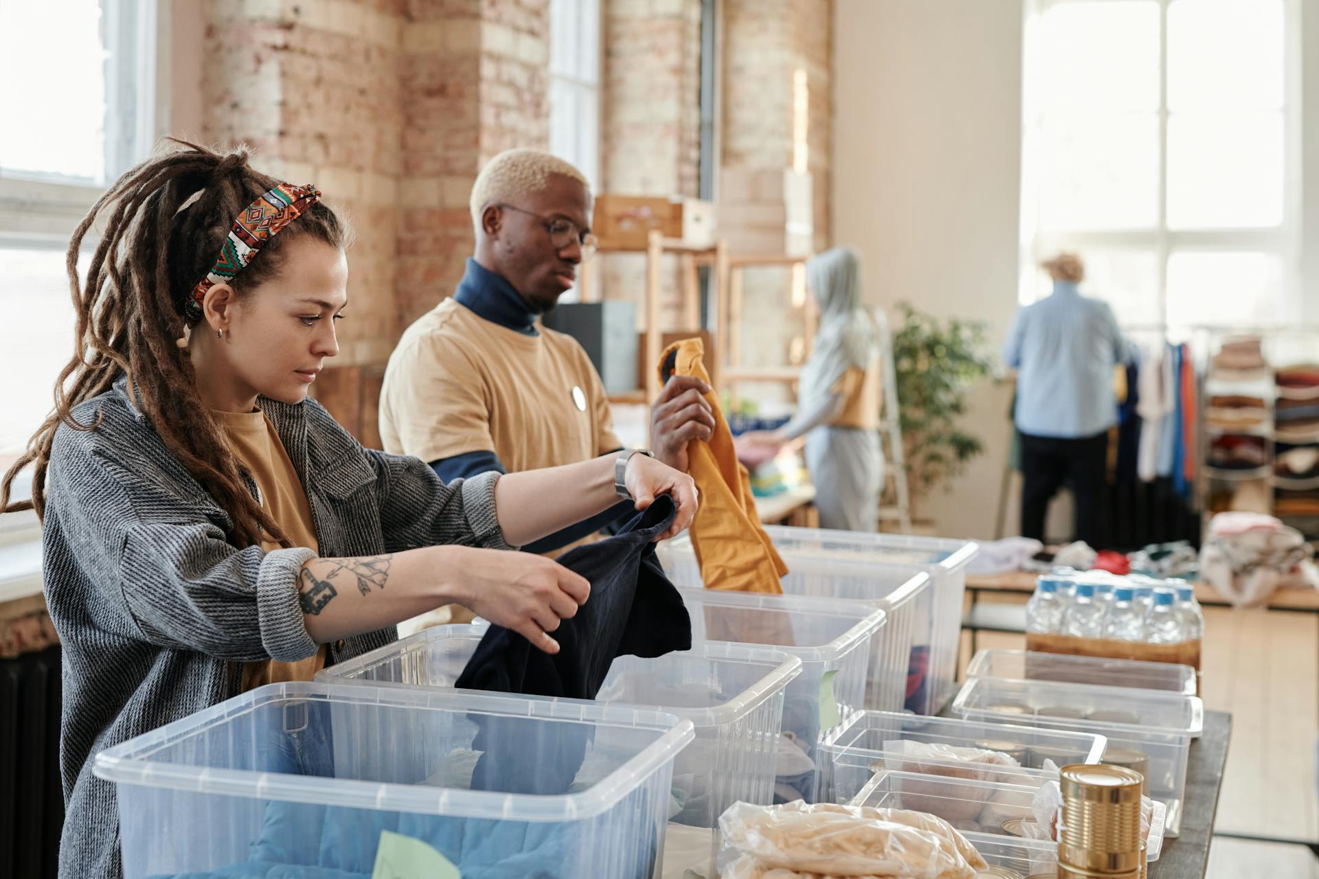 woman-with-dreadlocks-sorting-clothes