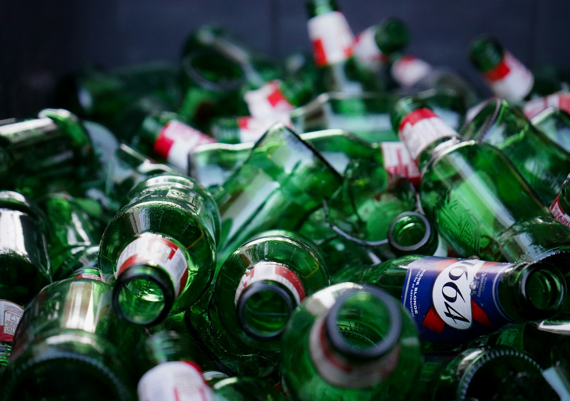 a-pile-of-empty-green-beer-bottles