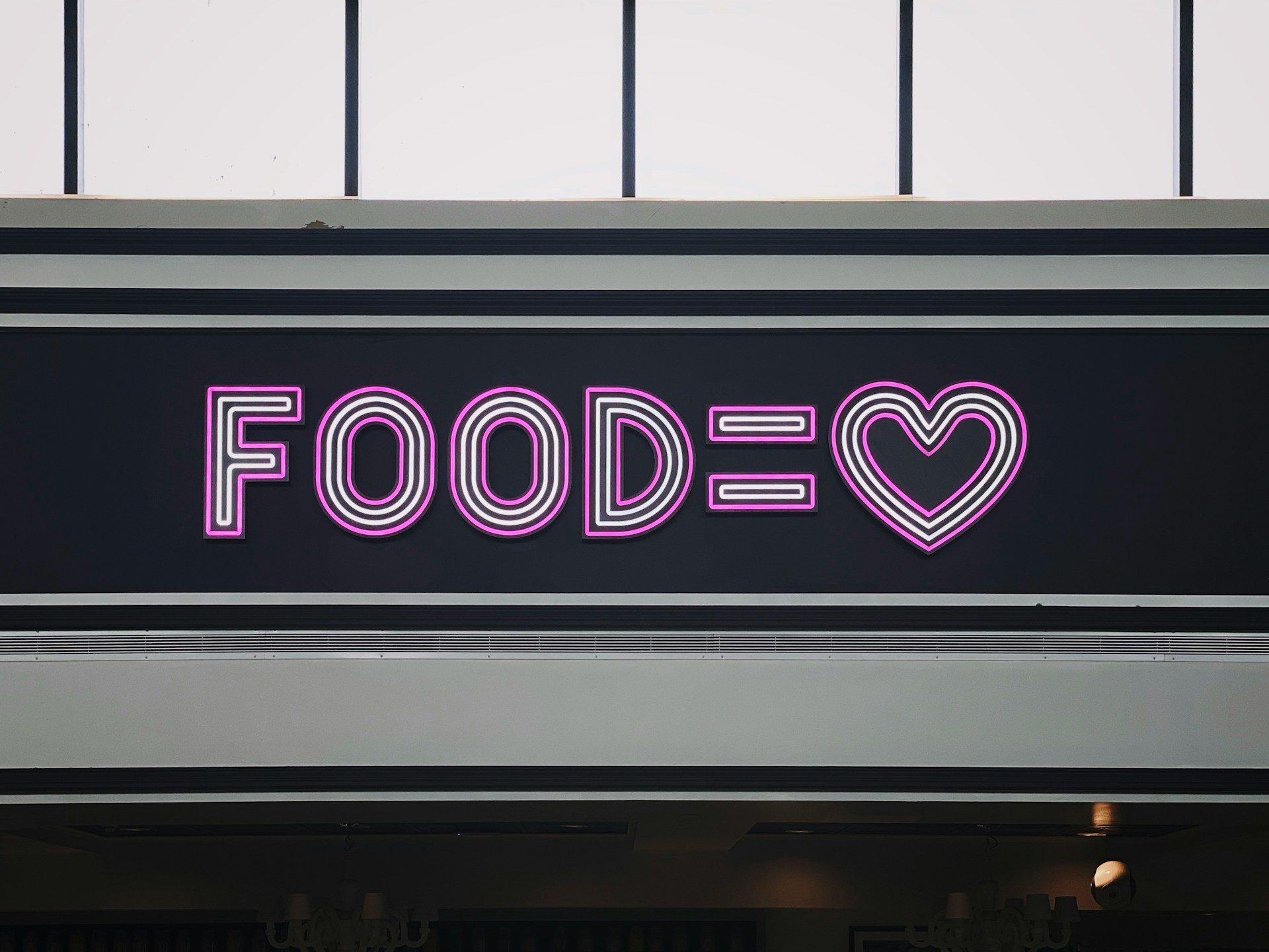 a-neon-sign-that-says-foodie-with-a-heart