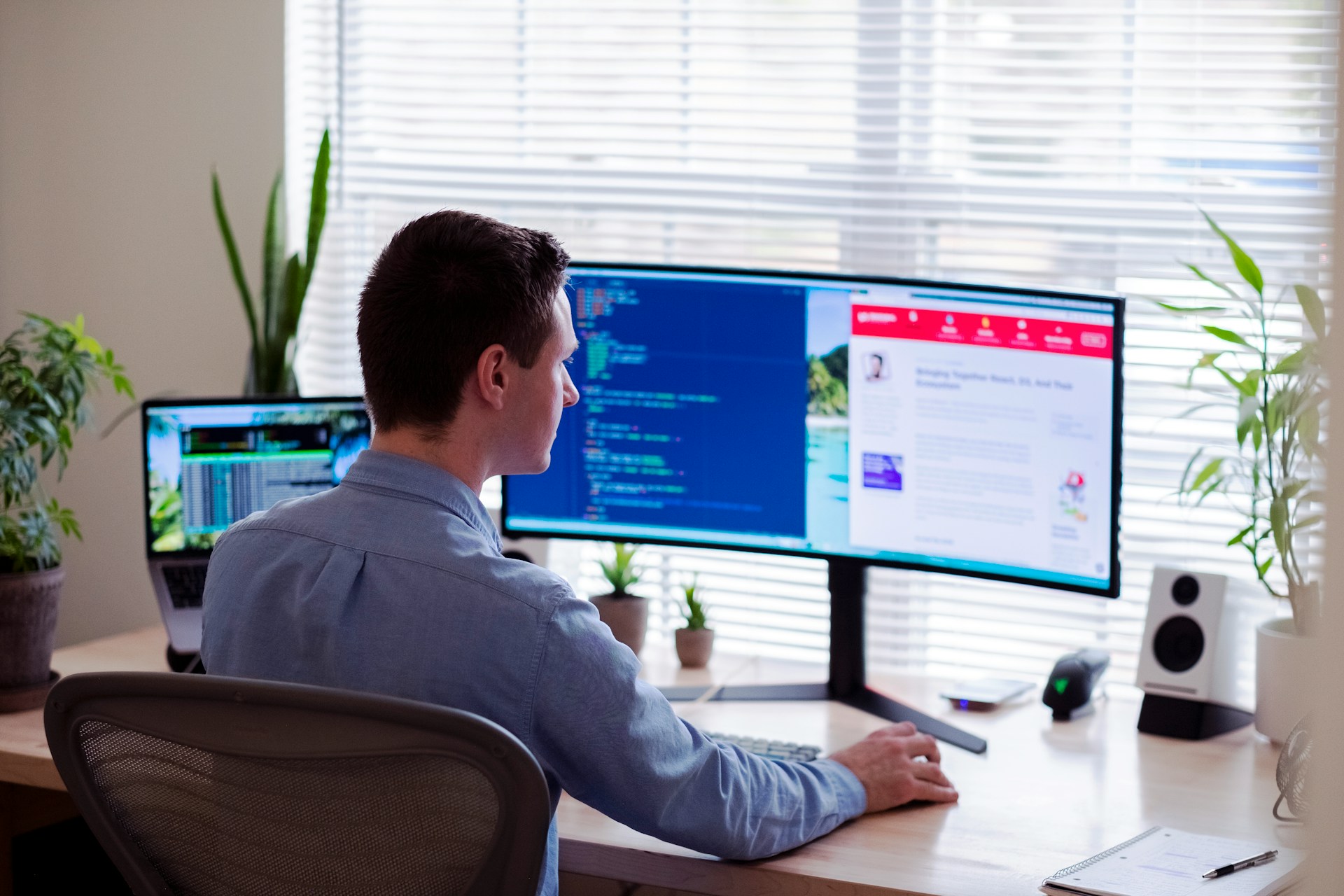 man-in-gray-dress-shirt-sitting-on-chair-in-front-of-computer-monitor